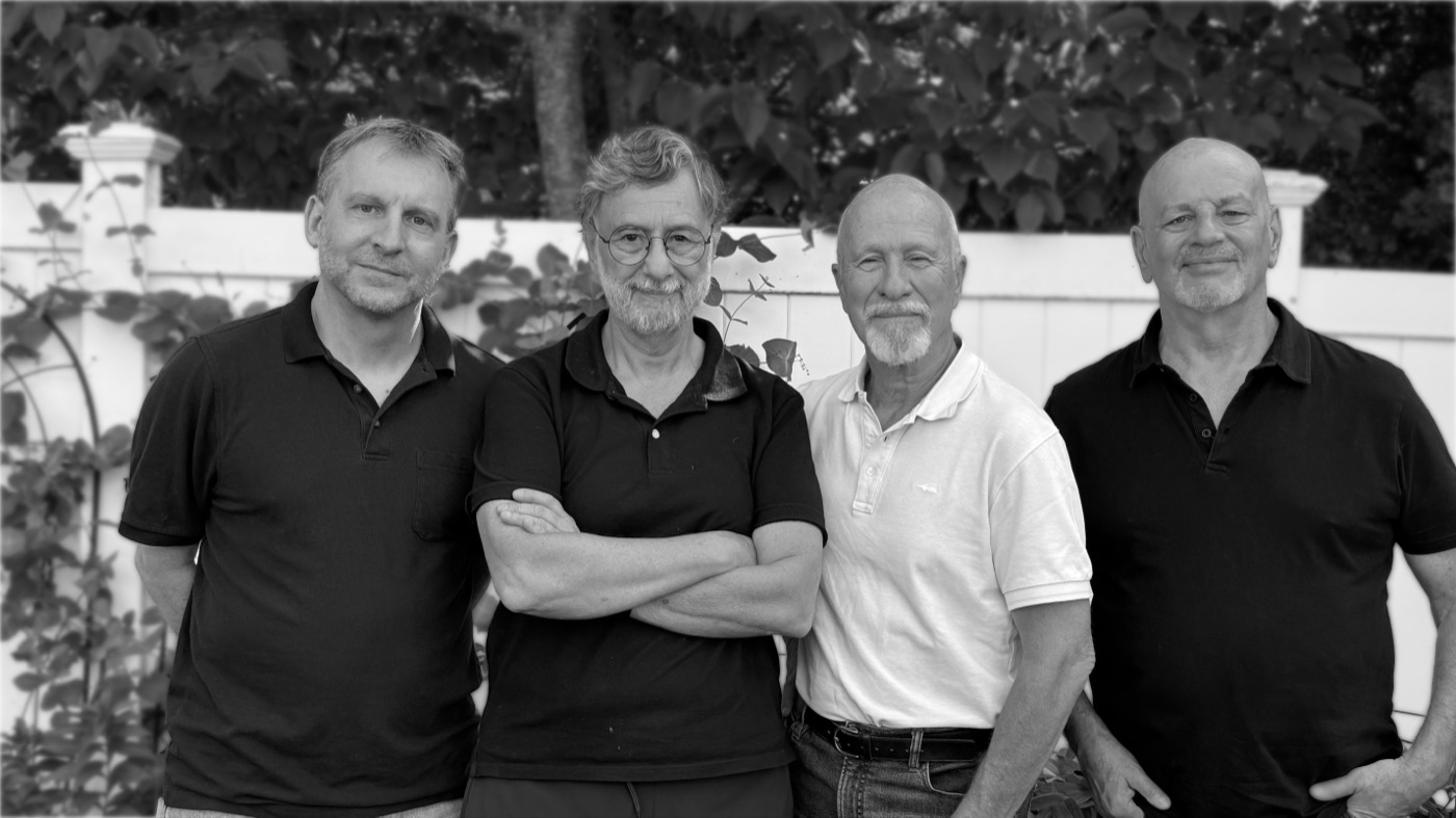 The four members of Offbeet outdoors in front of a white fence — left to right: Rob Coplan, Fabio Katz, Dan Sharon and Jim Gamo